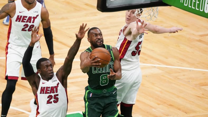 May 11, 2021; Boston, Massachusetts, USA; Boston Celtics guard Kemba Walker (8) makes the basket against Miami Heat guard Kendrick Nunn (25) and guard Duncan Robinson (55) in the third quarter at TD Garden. Mandatory Credit: David Butler II-USA TODAY Sports