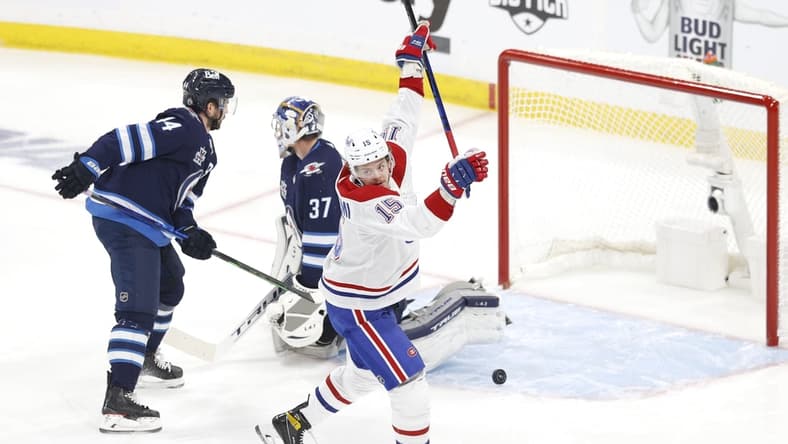 Jun 2, 2021; Winnipeg, Manitoba, CAN; Montreal Canadiens center Jesperi Kotkaniemi (15) scores a first period goal against Winnipeg Jets goaltender Connor Hellebuyck (37) in game one of the second round of the 2021 Stanley Cup Playoffs at Bell MTS Place. Mandatory Credit: James Carey Lauder-USA TODAY Sports