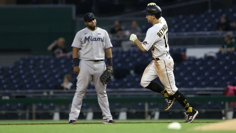 Jun 3, 2021; Pittsburgh, Pennsylvania, USA; Miami Marlins first baseman Jesus Aguilar (left) reacts as Pittsburgh Pirates center fielder Bryan Reynolds (10) circles the bases on a solo home run during the fourth inning at PNC Park. Mandatory Credit: Charles LeClaire-USA TODAY Sports