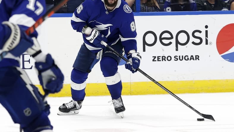 Jun 3, 2021; Tampa, Florida, USA; Tampa Bay Lightning right wing Nikita Kucherov (86) passes the puck against the Carolina Hurricanes during the third period in game three of the second round of the 2021 Stanley Cup Playoffs at Amalie Arena. Mandatory Credit: Kim Klement-USA TODAY Sports