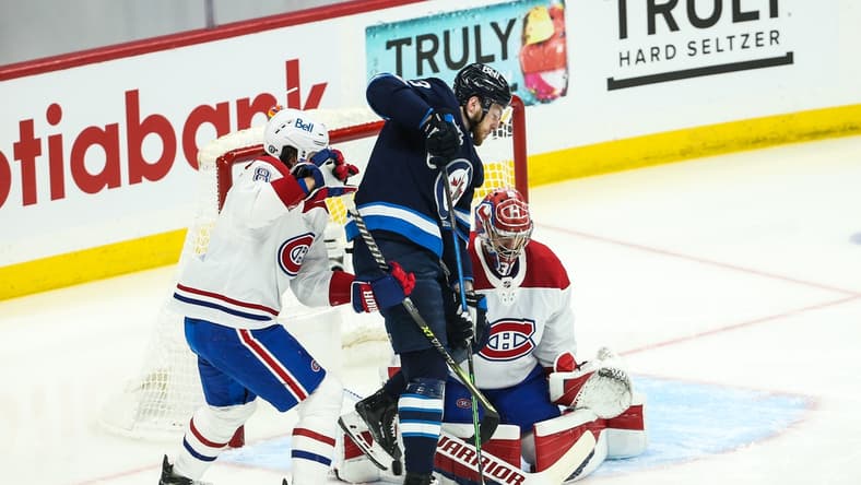 Jun 4, 2021; Winnipeg, Manitoba, CAN; Winnipeg Jets forward Pierre-Luc Dubois (13) tries to deflect the puck past Montreal Canadiens goalie Carey Price (31) during the first period in game two of the second round of the 2021 Stanley Cup Playoffs at Bell MTS Place. Mandatory Credit: Terrence Lee-USA TODAY Sports