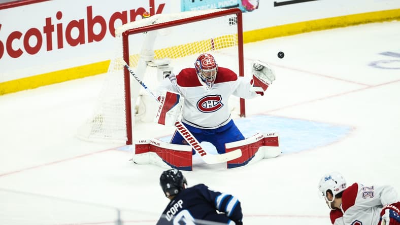 Jun 4, 2021; Winnipeg, Manitoba, CAN; Winnipeg Jets forward Andrew Copp (9) shoots wide of Montreal Canadiens goalie Carey Price (31) during the first period in game two of the second round of the 2021 Stanley Cup Playoffs at Bell MTS Place. Mandatory Credit: Terrence Lee-USA TODAY Sports
