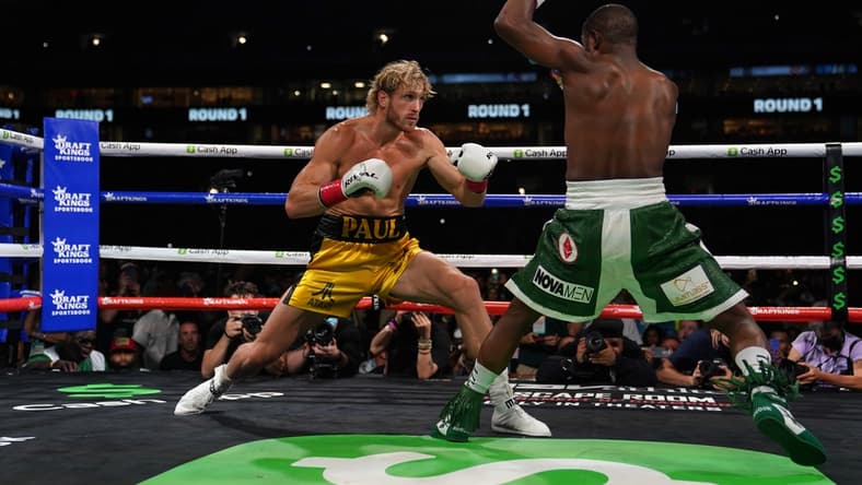 Jun 6, 2021; Miami, Florida, USA; Floyd Mayweather Jr. (Green Trunks) fights Logan Paul (Yellow Trunks) during an exhibition boxing match at Hard Rock Stadium. Mandatory Credit: Jasen Vinlove-USA TODAY Sports