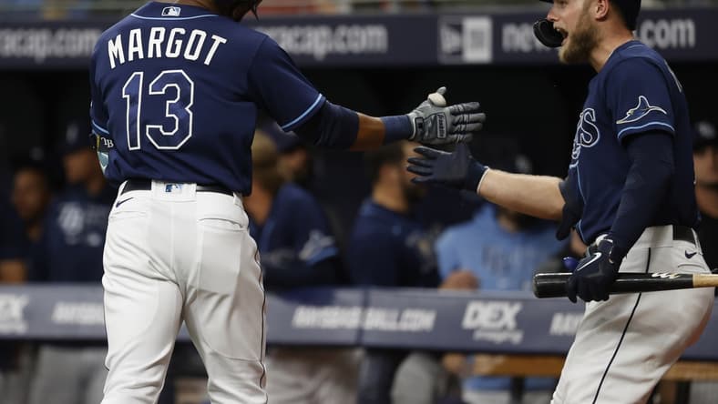 Jun 8, 2021; St. Petersburg, Florida, USA; Tampa Bay Rays right fielder Manuel Margot (13) is congratulated by designated hitter Austin Meadows (17) after he hits a home run against the Washington Nationals during the first inning at Tropicana Field. Mandatory Credit: Kim Klement-USA TODAY Sports