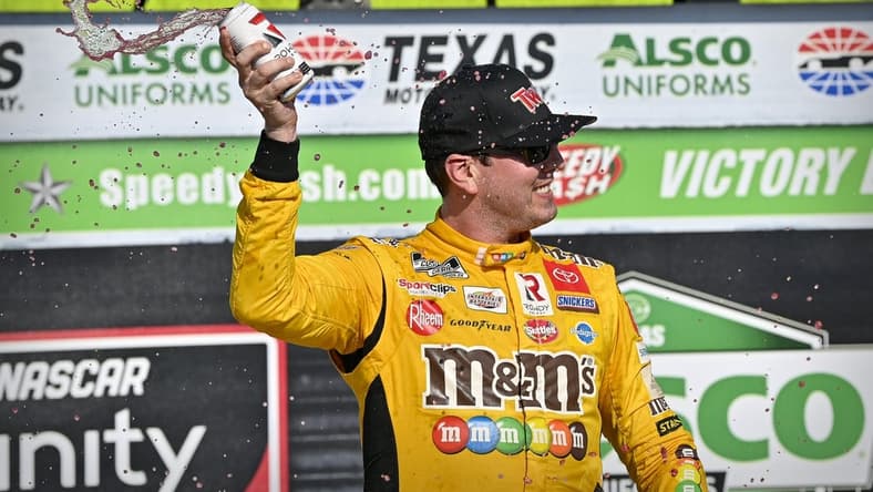 Jun 12, 2021; Fort Worth, TX, USA; NASCAR Xfinity Series driver Kyle Busch (54) celebrates in victory lane after he wins the Alsco Uniforms 250 race at Texas Motor Speedway. Mandatory Credit: Jerome Miron-USA TODAY Sports