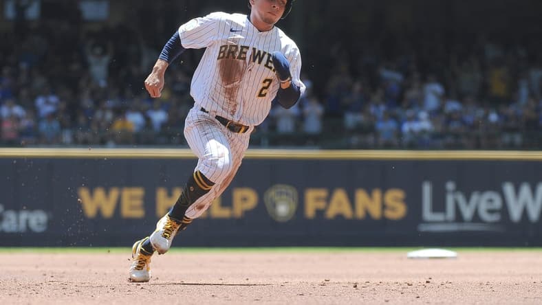 Jun 13, 2021; Milwaukee, Wisconsin, USA; Milwaukee Brewers third baseman Luis Urias (2) rounds second base to score a run against the Pittsburgh Pirates in the first inning at American Family Field. Mandatory Credit: Michael McLoone-USA TODAY Sports