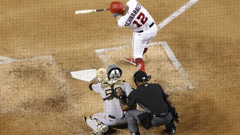 Jun 14, 2021; Washington, District of Columbia, USA; Washington Nationals left fielder Kyle Schwarber (12) hits a solo home run against the Pittsburgh Pirates in the seventh inning at Nationals Park. Mandatory Credit: Geoff Burke-USA TODAY Sports