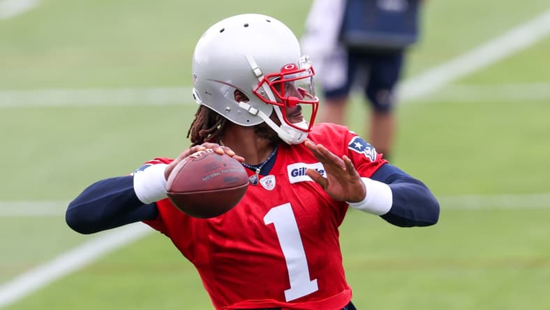 Jun 15, 2021; Foxborough, MA, USA; New England Patriots quarterback Cam Newton (1) participates in a drill during the New England Patriots mini camp at the New England Patriots practice complex. Mandatory Credit: Paul Rutherford-USA TODAY Sports