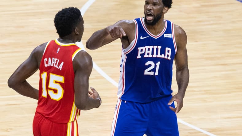 Jun 16, 2021; Philadelphia, Pennsylvania, USA; Philadelphia 76ers center Joel Embiid (21) reacts against Atlanta Hawks center Clint Capela (15) after a guard Ben Simmons (not pictured) dunk during the first quarter in game five of the second round of the 2021 NBA Playoffs at Wells Fargo Center. Mandatory Credit: Bill Streicher-USA TODAY Sports