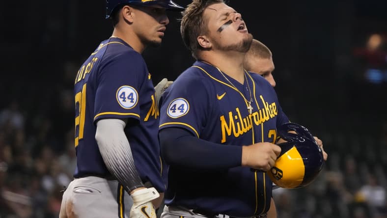 Jun 22, 2021; Phoenix, Arizona, USA; Milwaukee Brewers first baseman Daniel Vogelbach (20) reacts after injuring himself against the Arizona Diamondbacks in the sixth inning at Chase Field. Mandatory Credit: Rick Scuteri-USA TODAY Sports