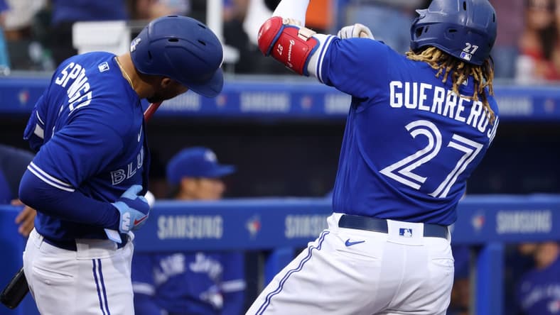 Jun 25, 2021; Buffalo, New York, USA; Toronto Blue Jays first baseman Vladimir Guerrero Jr. (27) celebrates his home run with center fielder George Springer (4) during the third inning against Baltimore Orioles at Sahlen Field. Mandatory Credit: Timothy T. Ludwig-USA TODAY Sports