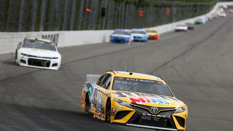 Jun 26, 2021; Long Pond, Pennsylvania, USA; NASCAR Cup Series driver Kyle Busch (18) leads driver William Byron (24) during the Pocono Organics CBD 325 at Pocono Raceway. Mandatory Credit: Matthew OHaren-USA TODAY Sports