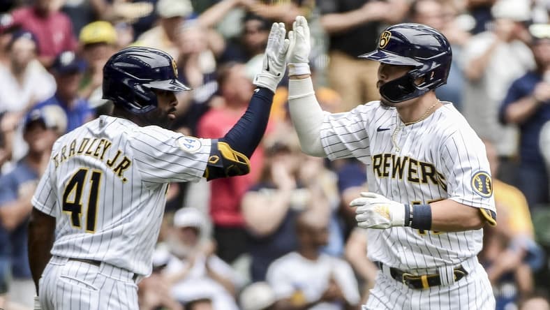 Jun 27, 2021; Milwaukee, Wisconsin, USA; Milwaukee Brewers first baseman Keston Hiura (18) is greeted by center fielder Jackie Bradley Jr. (41) after hitting a solo home run in the third inning against the Colorado Rockies at American Family Field. Mandatory Credit: Benny Sieu-USA TODAY Sports