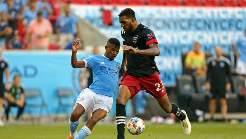 Jun 27, 2021; Harrison, New Jersey, USA; New York City FC forward Thiago Andrade (8) kicks the game-winning goal while D.C. United defender Donovan Pines (23) tries to defend during the second half of a game between D.C. United and NYCFC at Red Bull Arena. Mandatory Credit: Danny Wild-USA TODAY Sports