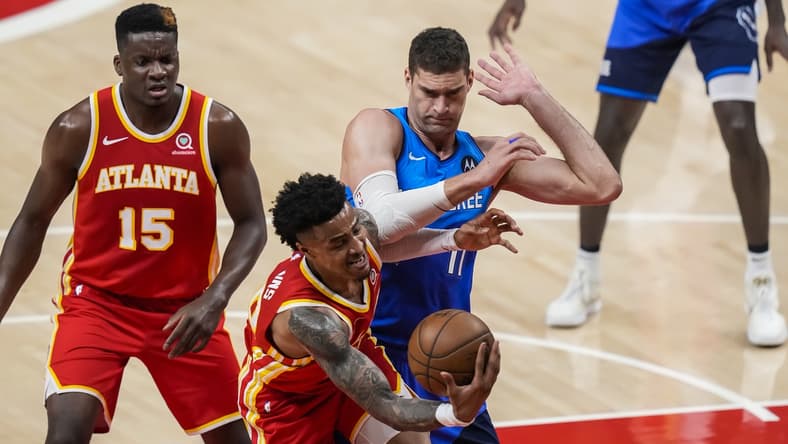 Jun 27, 2021; Atlanta, Georgia, USA; Atlanta Hawks forward John Collins (20) competes for rebound against Milwaukee Bucks center Brook Lopez (11) during the first quarter during game three of the Eastern Conference Finals for the 2021 NBA Playoffs at State Farm Arena. Mandatory Credit: Dale Zanine-USA TODAY Sports