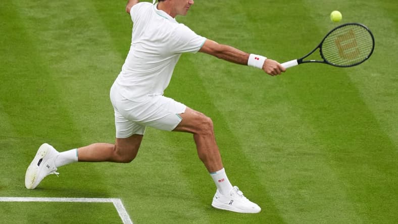 Jun 29, 2021; London, United Kingdom;  Roger Federer (SUI) in action Adrian Mannarino (FRA) in first round  singles on centre court at All England Lawn Tennis and Croquet Club. Mandatory Credit: Peter Van den Berg-USA TODAY Sports
