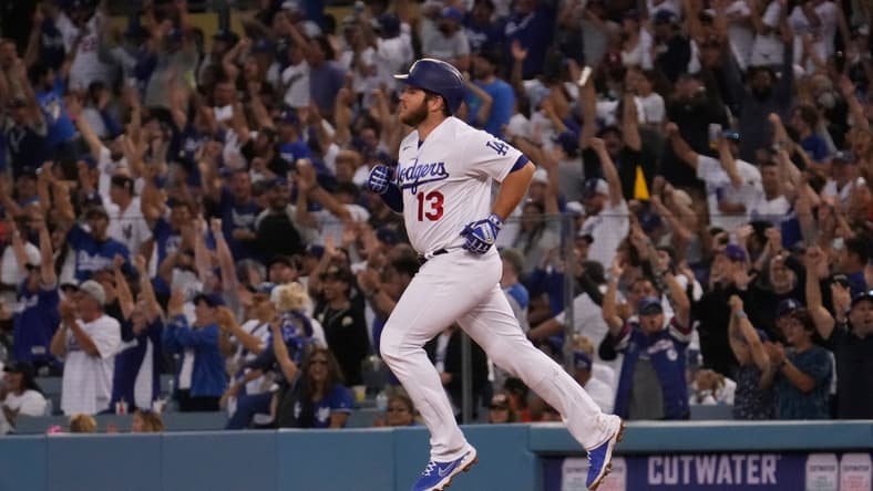 Jun 29, 2021; Los Angeles, California, USA; Fans cheer as Los Angeles Dodgers first baseman Max Muncy (13) rounds the bases after hitting a home run in the fourth inning against the San Francisco Giants at Dodger Stadium. Mandatory Credit: Robert Hanashiro-USA TODAY Sports