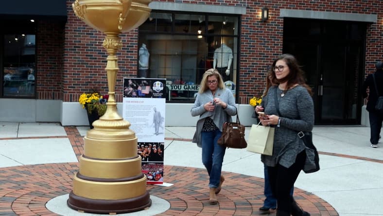 Women walk by a large replica of the Ryder Cup trophy at Kohler Food and Wine, Friday, October 19, 2018, in Kohler, Wis. The Ryder Cup will be at Whistling Straits in 2020

101918 She Kohler Food And Wine Gck 12