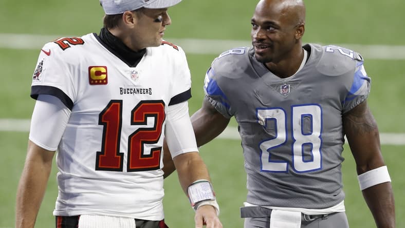 Dec 26, 2020; Detroit, Michigan, USA; Detroit Lions running back Adrian Peterson (28) talks with Tampa Bay Buccaneers quarterback Tom Brady (12) after the game at Ford Field. Mandatory Credit: Raj Mehta-USA TODAY Sports