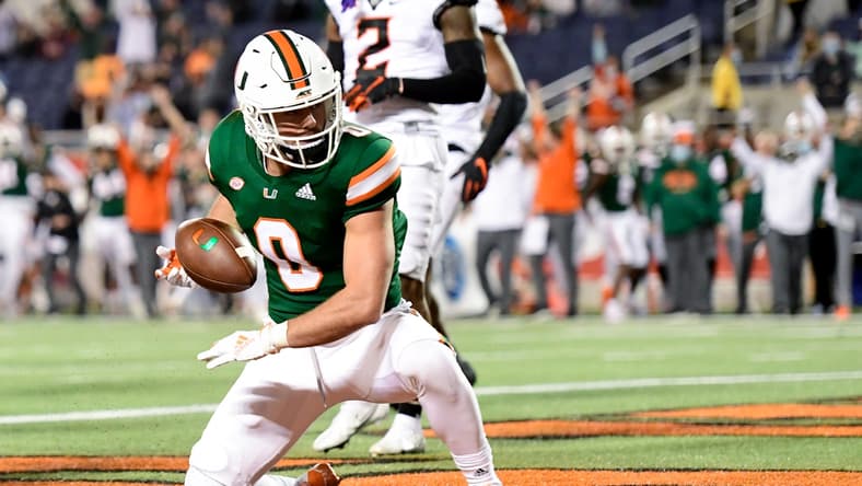 Dec 29, 2020; Orlando, FL, USA; Miami Hurricanes wide receiver Marshall Few (0) reacts after running the ball in for a two-point conversion during the second half against the Oklahoma State Cowboys during the Cheez-It Bowl Game at Camping World Stadium. Mandatory Credit: Douglas DeFelice-USA TODAY Sports