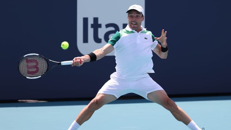 Apr 2, 2021; Miami, Florida, USA; Roberto Bautista Agut of Spain hits a forehand against Jannik Sinner of Italy (not pictured) in a men's singles semifinal in the Miami Open at Hard Rock Stadium. Mandatory Credit: Geoff Burke-USA TODAY Sports