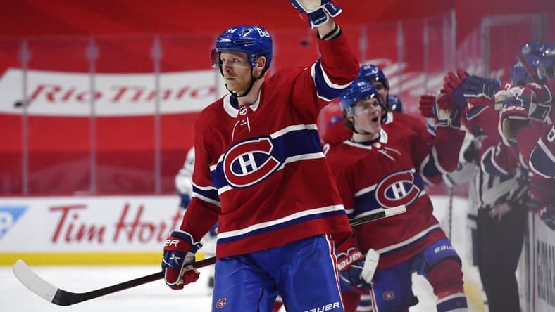 May 29, 2021; Montreal, Quebec, CAN; Montreal Canadiens forward Corey Perry (94) reacts with teammates including Cole Caufield (22) after scoring a goal against the Toronto Maple Leafs during the third period in game six of the first round of the 2021 Stanley Cup Playoffs at the Bell Centre. Mandatory Credit: Eric Bolte-USA TODAY Sports