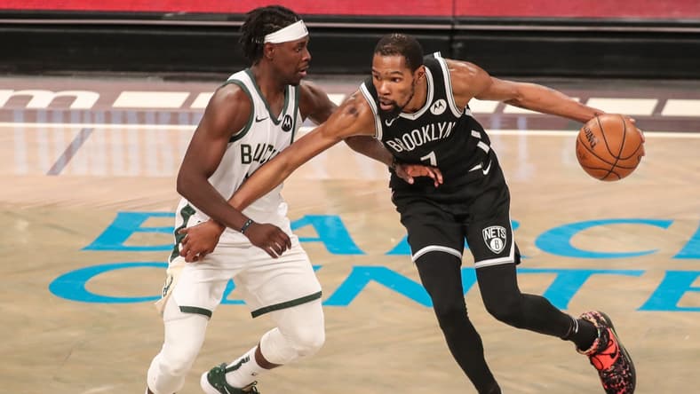 Jun 19, 2021; Brooklyn, New York, USA; Milwaukee Bucks guard Jrue Holiday (21) and Brooklyn Nets forward Kevin Durant (7) during game seven in the second round of the 2021 NBA Playoffs at Barclays Center. Mandatory Credit: Wendell Cruz-USA TODAY Sports