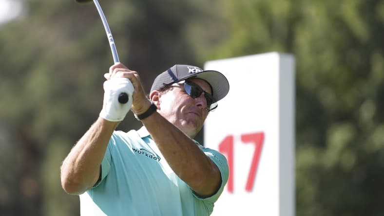 Jul 1, 2021; Detroit, Michigan, USA; Phil Mickelson tees off on the 17th hole during the first round of the Rocket Mortgage Classic golf tournament. Mandatory Credit: Raj Mehta-USA TODAY Sports