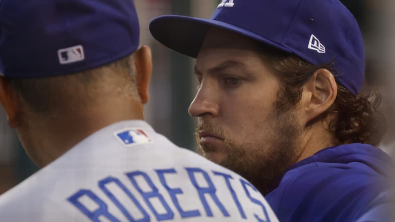 Jul 1, 2021; Washington, District of Columbia, USA; Los Angeles Dodgers starting pitcher Trevor Bauer (R) talks with Dodgers manager Dave Roberts (L) in the dugout against the Washington Nationals in the third inning at Nationals Park. Mandatory Credit: Geoff Burke-USA TODAY Sports