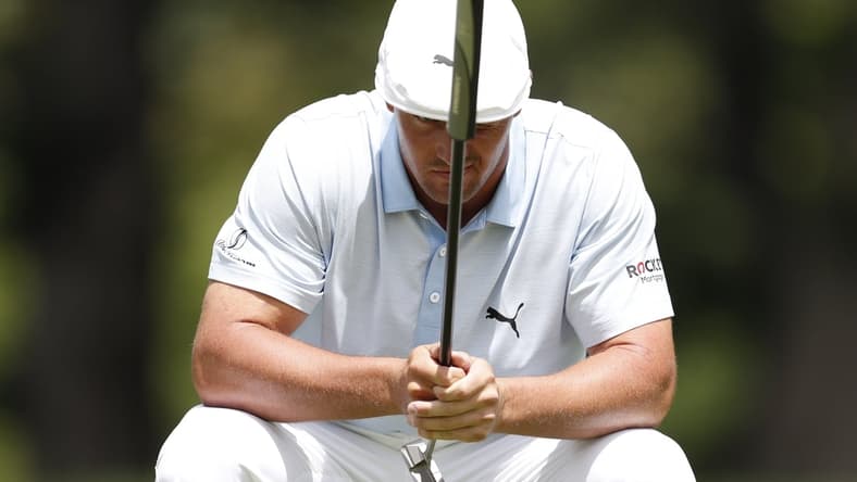 Jul 2, 2021; Detroit, Michigan, USA; Bryson DeChambeau lines up his putt on the 9th hole during the second round of the Rocket Mortgage Classic golf tournament. Mandatory Credit: Raj Mehta-USA TODAY Sports