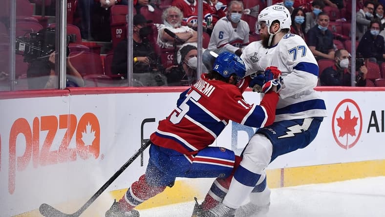 Jul 2, 2021; Montreal, Quebec, CAN; Montreal Canadiens center Jesperi Kotkaniemi (15) and Tampa Bay Lightning defenseman Victor Hedman (77) battle for the puck during the first period in game three of the 2021 Stanley Cup Final at the Bell Centre. Mandatory Credit: Eric Bolte-USA TODAY Sports