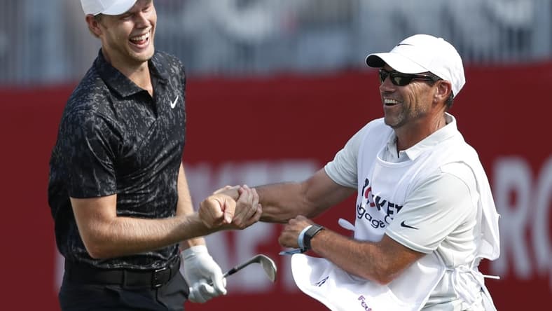 Jul 4, 2021; Detroit, Michigan, USA; Cam Davis celebrates with his caddie after making an eagle from a greenside bunker on the 17th hole during the final round of the Rocket Mortgage Classic golf tournament. Mandatory Credit: Raj Mehta-USA TODAY Sports
