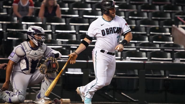 Jul 6, 2021; Phoenix, Arizona, USA; Arizona Diamondbacks catcher Stephen Vogt (21) hits a single against the Colorado Rockies in the ninth inning at Chase Field. Mandatory Credit: Rick Scuteri-USA TODAY Sports