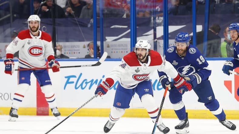 Jul 7, 2021; Tampa, Florida, USA; Montreal Canadiens left wing Phillip Danault (24) reaches for the puck against the Tampa Bay Lightning during the first period in game five of the 2021 Stanley Cup Final at Amalie Arena. Mandatory Credit: Kim Klement-USA TODAY Sports
