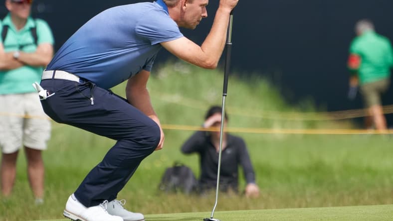 Jul 16, 2021; Sandwich, England, GB; Marcel Siem lines up a putt on the fifth green during the second  round of the Open Championship golf tournament. Mandatory Credit: Peter van den Berg-USA TODAY Sports