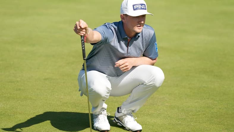 Jul 16, 2021; Sandwich, England, GB; Mackenzie Hughes  lines up a putt on the sixth green during the second  round of the Open Championship golf tournament. Mandatory Credit: Peter van den Berg-USA TODAY Sports