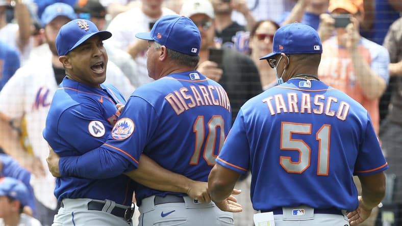 Jul 18, 2021; Pittsburgh, Pennsylvania, USA; New York Mets manager Luis Rojas (left) reacts while being restrained by third base coach Gary Disarcina (10) and first base coach Tony Tarasco (51) after Rojas was ejected from the game against the Pittsburgh Pirates during the first inning at PNC Park. Mandatory Credit: Charles LeClaire-USA TODAY Sports
