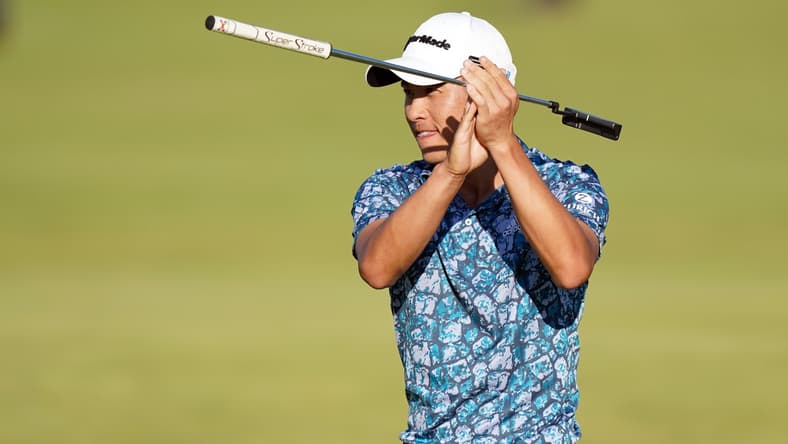 Jul 18, 2021; Sandwich, England, GBR; Collin Morikawa applauds the crowds in the stand of the 18 hole as he wins  the Open Championship golf tournament. Mandatory Credit: Peter van den Berg-USA TODAY Sports