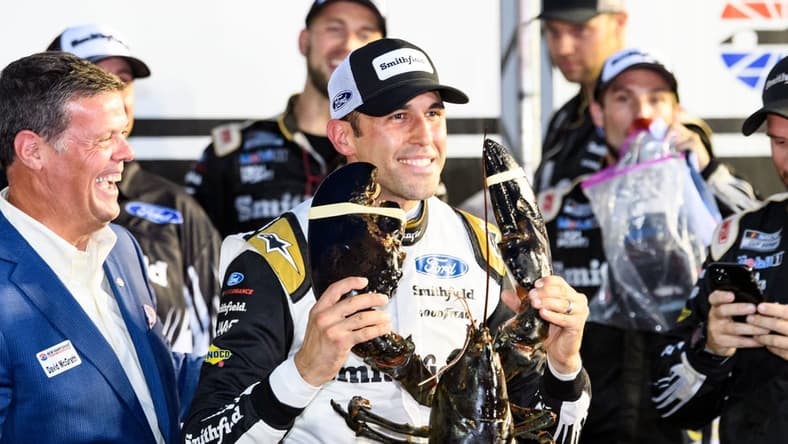Jul 18, 2021; Loudon, New Hampshire, USA; NASCAR Cup Series driver Aric Almirola (10) holds up a lobster after winning the Foxwoods Resort Casino 301 at the New Hampshire Motor Speedway. Mandatory Credit: Brian Fluharty-USA TODAY Sports