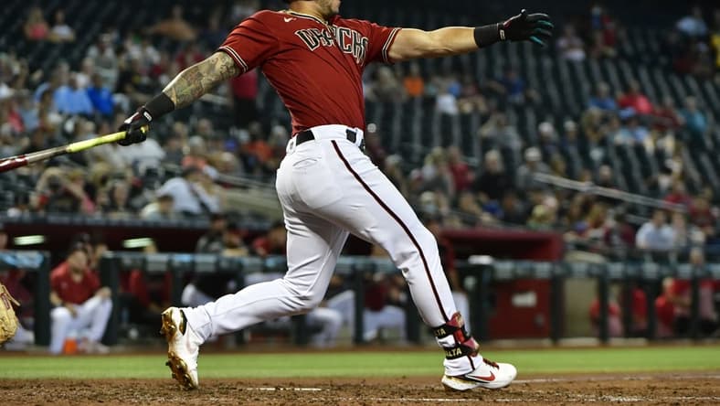 Jul 21, 2021; Phoenix, Arizona, USA;  Arizona Diamondbacks left fielder David Peralta (6) hits an RBI double in the third inning against the Pittsburgh Pirates at Chase Field. Mandatory Credit: Matt Kartozian-USA TODAY Sports