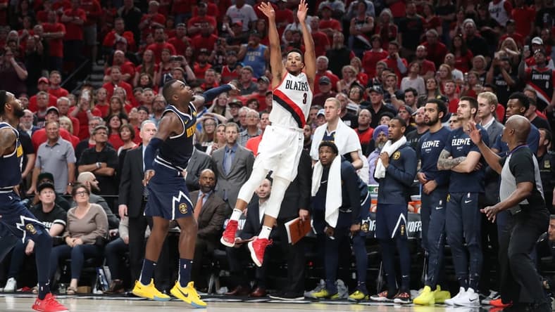 May 5, 2019; Portland, OR, USA; Portland Trail Blazers guard CJ McCollum (3) scores over Denver Nuggets forward Paul Millsap (4) in the second half of game four of the second round of the 2019 NBA Playoffs at Moda Center. Mandatory Credit: Jaime Valdez-USA TODAY Sports