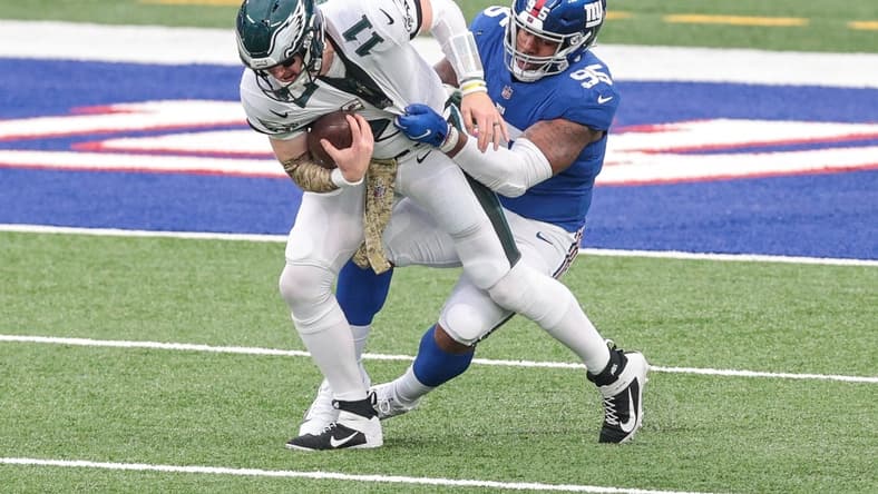 Nov 15, 2020; East Rutherford, New Jersey, USA; Philadelphia Eagles quarterback Carson Wentz (11) is sacked by New York Giants defensive tackle B.J. Hill (95) during the first half at MetLife Stadium. Mandatory Credit: Vincent Carchietta-USA TODAY Sports