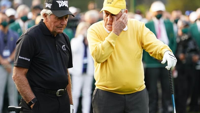 Apr 8, 2021; Augusta, Georgia, USA; Jack Nicklaus wipes a tear as Gary Player looks on at the first tee during the first round of The Masters golf tournament. Mandatory Credit: Rob Schumacher-USA TODAY Sports