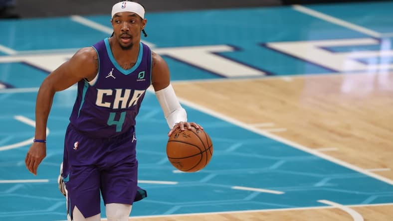 Apr 27, 2021; Charlotte, North Carolina, USA; Charlotte Hornets guard Devonte' Graham (4) brings the ball up court against the Milwaukee Bucks in the first half at Spectrum Center. The Milwaukee Bucks won 114-104. Mandatory Credit: Nell Redmond-USA TODAY Sports