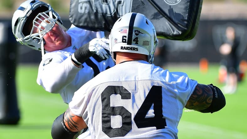 Jul 28, 2021; Las Vegas, NV, USA; Las Vegas Raiders guard Richie Incognito (64) puts a hit on tackle Sam Young (79) during a team practice at Intermountain Healthcare Performance Center in Henderson. Mandatory Credit: Stephen R. Sylvanie-USA TODAY Sports
