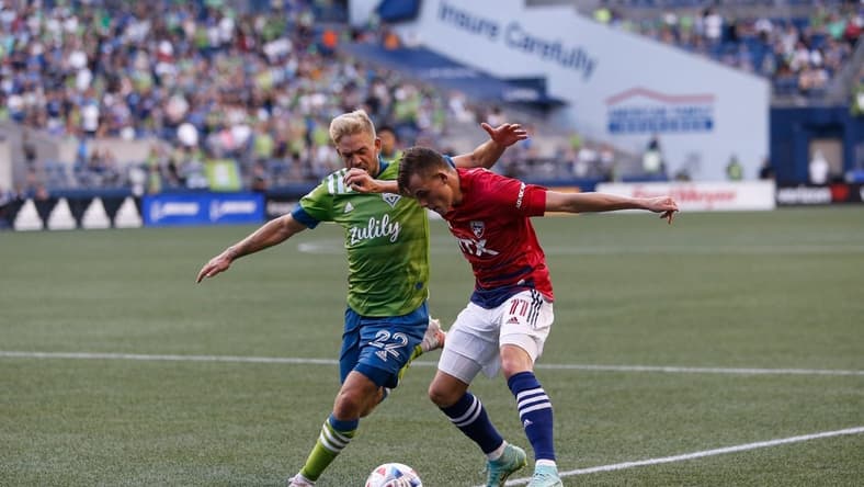 Aug 4, 2021; Seattle, Washington, USA; FC Dallas forward Szabolcs Schon (11) tries to get a shot off as Seattle Sounders FC midfielder Kelyn Rowe (22) defends during the first half at Lumen Field. Mandatory Credit: Jennifer Buchanan-USA TODAY Sports