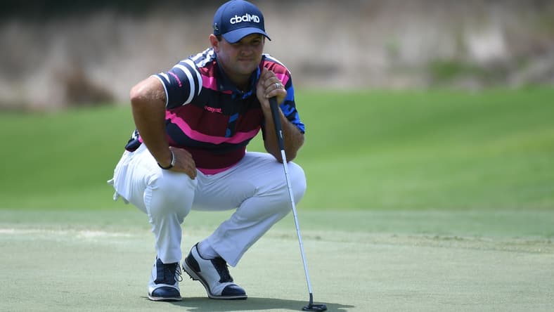 Aug 5, 2021; Memphis, Tennessee, USA; Patrick Reed lines up a putt on the 13th hole during the first round of the WGC FedEx St. Jude Invitational golf tournament at TPC Southwind. Mandatory Credit: Christopher Hanewinckel-USA TODAY Sports
