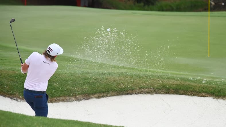 Aug 6, 2021; Memphis, Tennessee, USA; Cameron Smith makes a shot from the bunker on the third hole during the second round of the WGC FedEx St. Jude Invitational golf tournament at TPC Southwind. Mandatory Credit: Christopher Hanewinckel-USA TODAY Sports