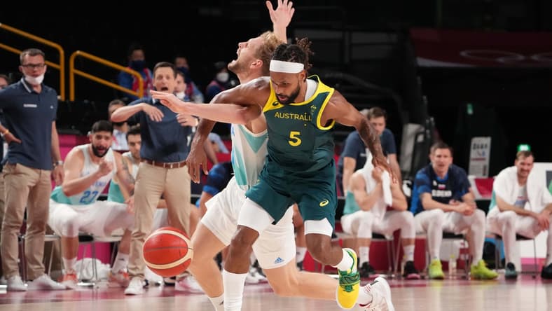 Aug 7, 2021; Saitama, Team Australia point guard Patty Mills (5) knocks the ball away from Japan; Team Slovenia shooting guard Jaka Blazic (11) in the second half during the Tokyo 2020 Olympic Summer Games at Saitama Super Arena. Mandatory Credit: Kyle Terada-USA TODAY Sports