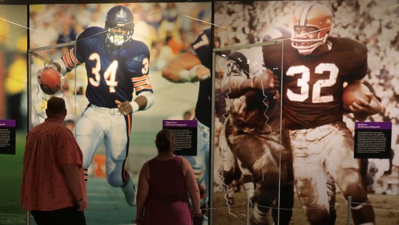 Fans look at the photo display in the HOF museum the Pro Football Hall of Fame Enshrinement ceremony Sunday, Aug. 8, 2021 at Tom Benson Hall of Fame Stadium in Canton, Ohio.
Hof Calvin